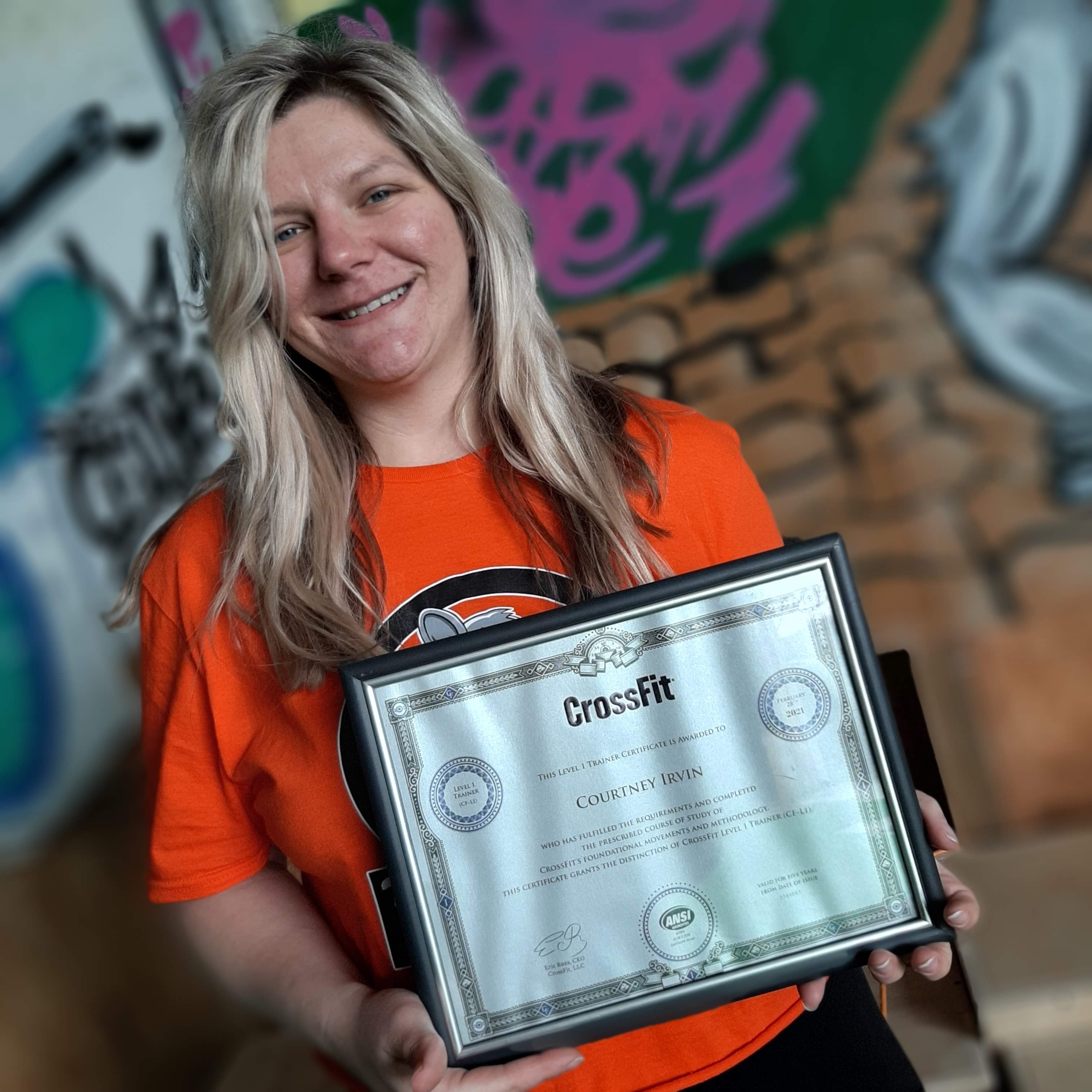 Courtney Jo holding her CrossFit Level 1 certificate