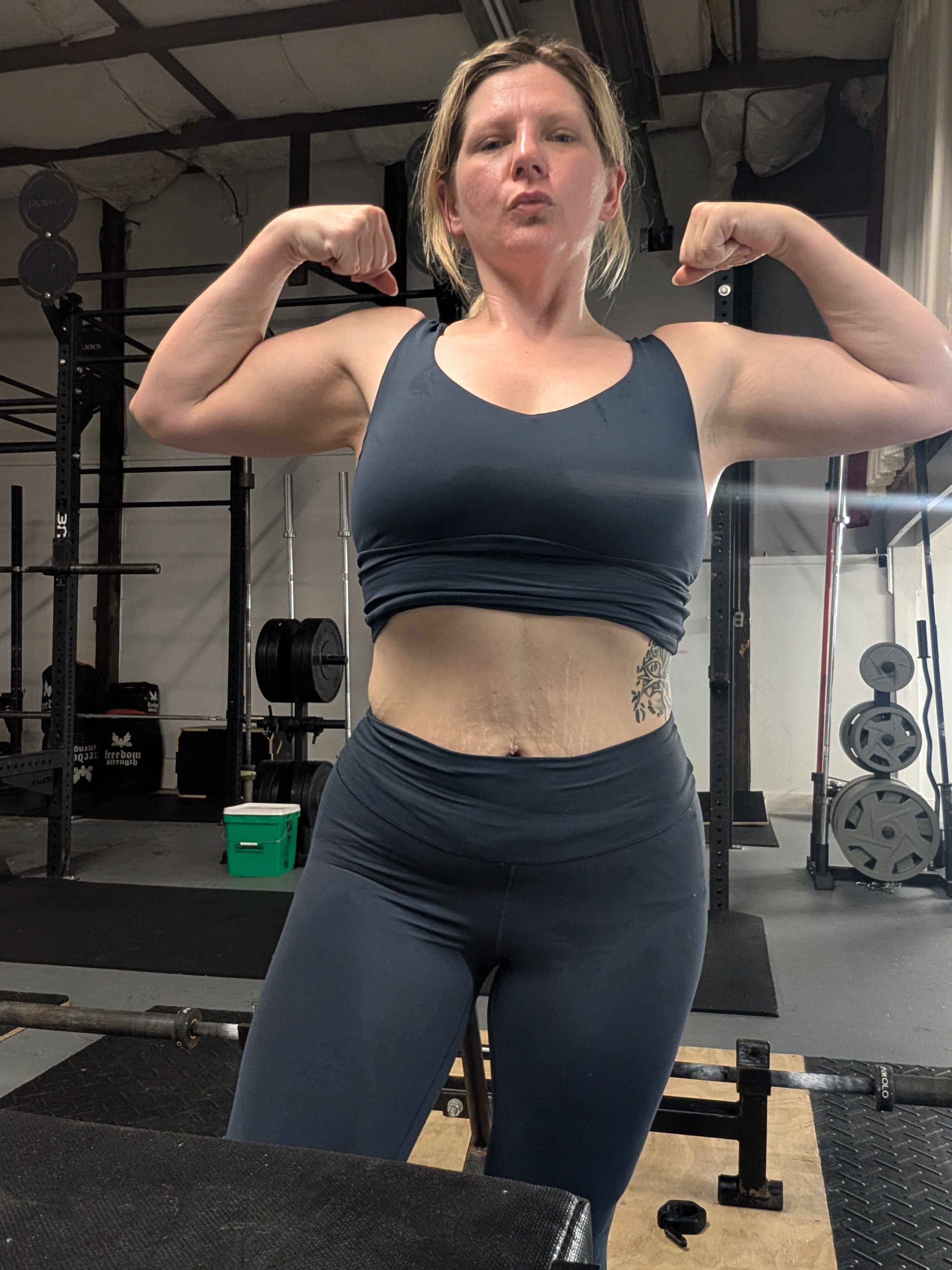 Courtney Jo flexing in the gym